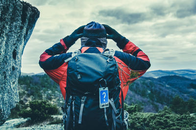 Man standing on mountain against sky