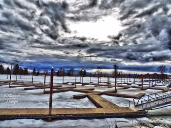 Scenic view of beach against sky during winter