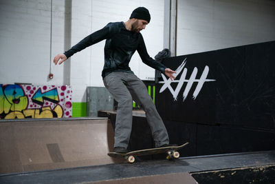 Full length of man skateboarding on wall