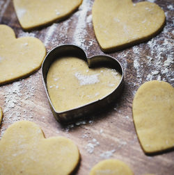 Christmas baking gingerbread. cookie dough in heart and star shape on kitchen counter. top view.