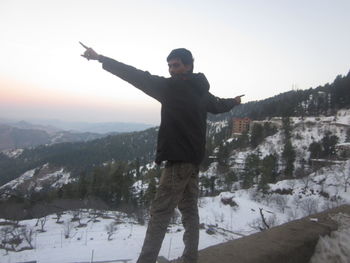 Man standing on snow covered mountain