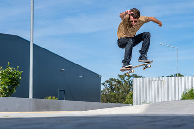 Low angle view of man climbing on footpath