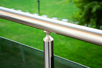 Close-up of railing by fence