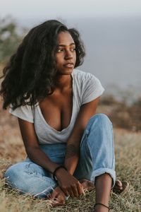 Young woman sitting on field