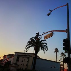 Low angle view of street light against blue sky