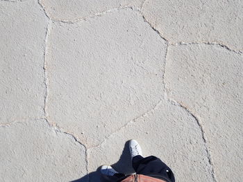 Low section of man standing on footpath