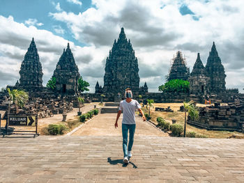 Full length of man standing outside temple against building