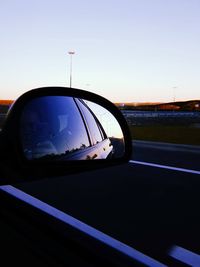 Reflection on side-view mirror of car