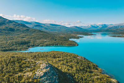 View of lake by mountain against sky