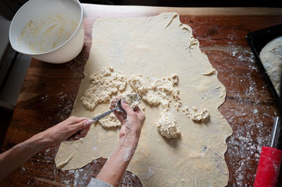 Midsection of person preparing food on table