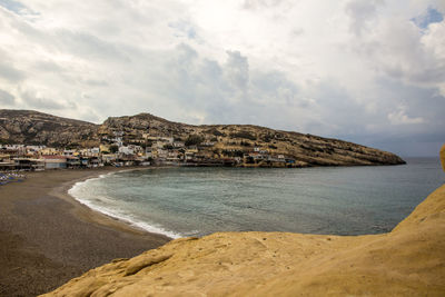 Scenic view of sea and buildings against sky