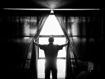 Rear view of boy standing in corridor