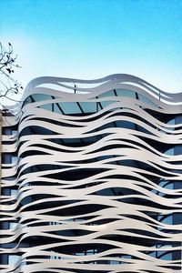 Low angle view of modern building against clear blue sky