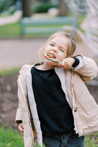 Young woman blowing bubbles on field