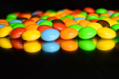 Close-up of multi colored candies against black background