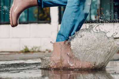 Low section of man on wet shore