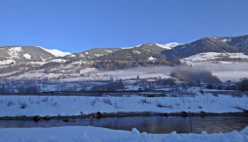 Scenic view of frozen lake against mountain range