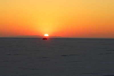 Scenic view of sea against orange sky