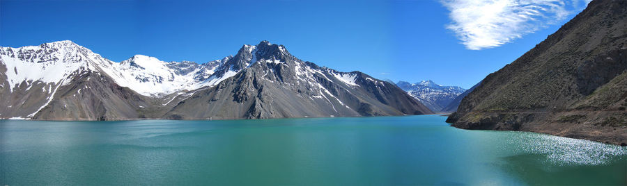 Panoramic view of lake and mountains against blue sky