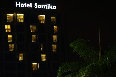 Illuminated text on building at night
