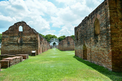 View of old building against cloudy sky