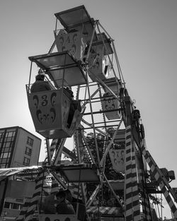 Low angle view of ferris wheel against sky