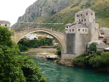 View of bridge over river against mountain