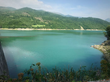 Scenic view of lake and mountains against sky