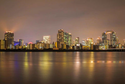 Illuminated skyscrapers at waterfront