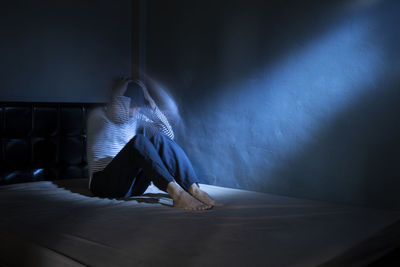 Low section of woman sitting on floor at home