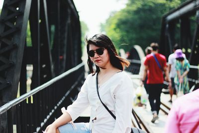 Young woman wearing sunglasses standing outdoors