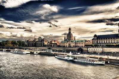 Boats in river with city in background