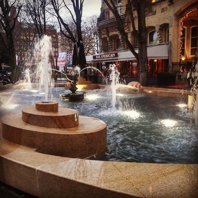 FOUNTAIN WITH BUILDINGS IN BACKGROUND