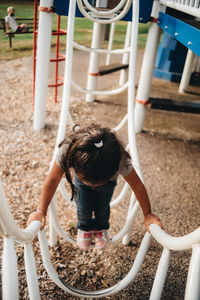 Rear view of girl playing in playground