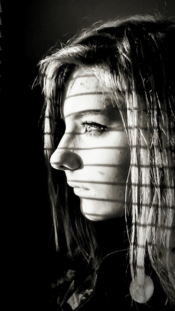 studio shot, headshot, person, indoors, young adult, front view, close-up, young women, portrait, black background, lifestyles, human face, long hair, looking at camera, waist up, head and shoulders, leisure activity