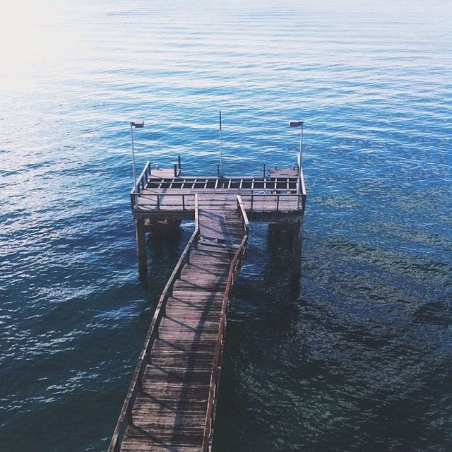 water, transportation, nautical vessel, boat, sea, pier, rippled, mode of transport, wood - material, tranquility, moored, jetty, nature, the way forward, tranquil scene, waterfront, day, lake, outdoors, high angle view