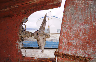 Close-up of rusty hanging on wall