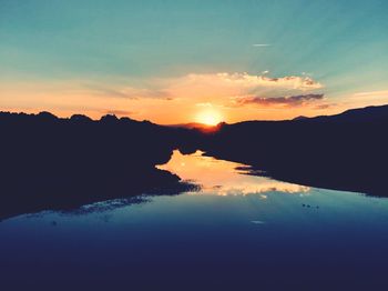 Scenic view of lake against sky during sunset