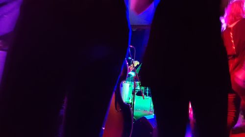 Low angle view of illuminated lighting equipment at night