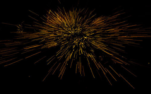 Low angle view of firework display at night