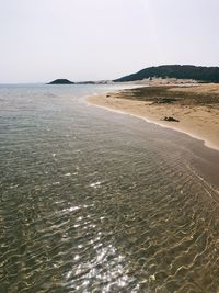 Scenic view of beach against clear sky