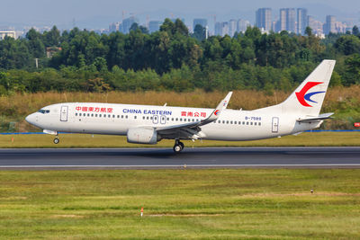 Airplane on airport runway against sky