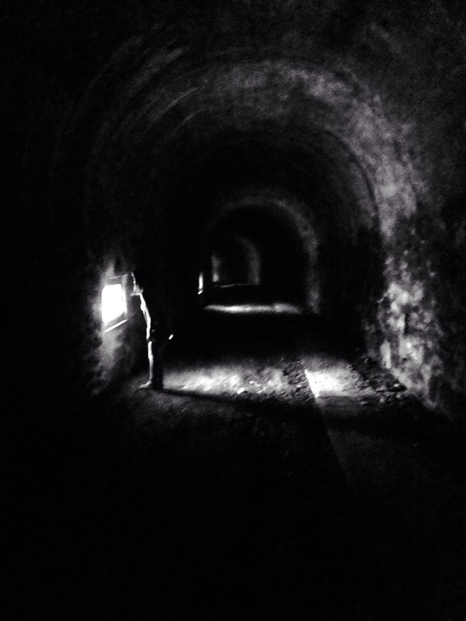 tunnel, lifestyles, full length, men, leisure activity, indoors, walking, rear view, silhouette, arch, the way forward, dark, person, night, illuminated, standing, unrecognizable person