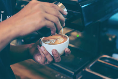 Close-up of woman holding coffee cup