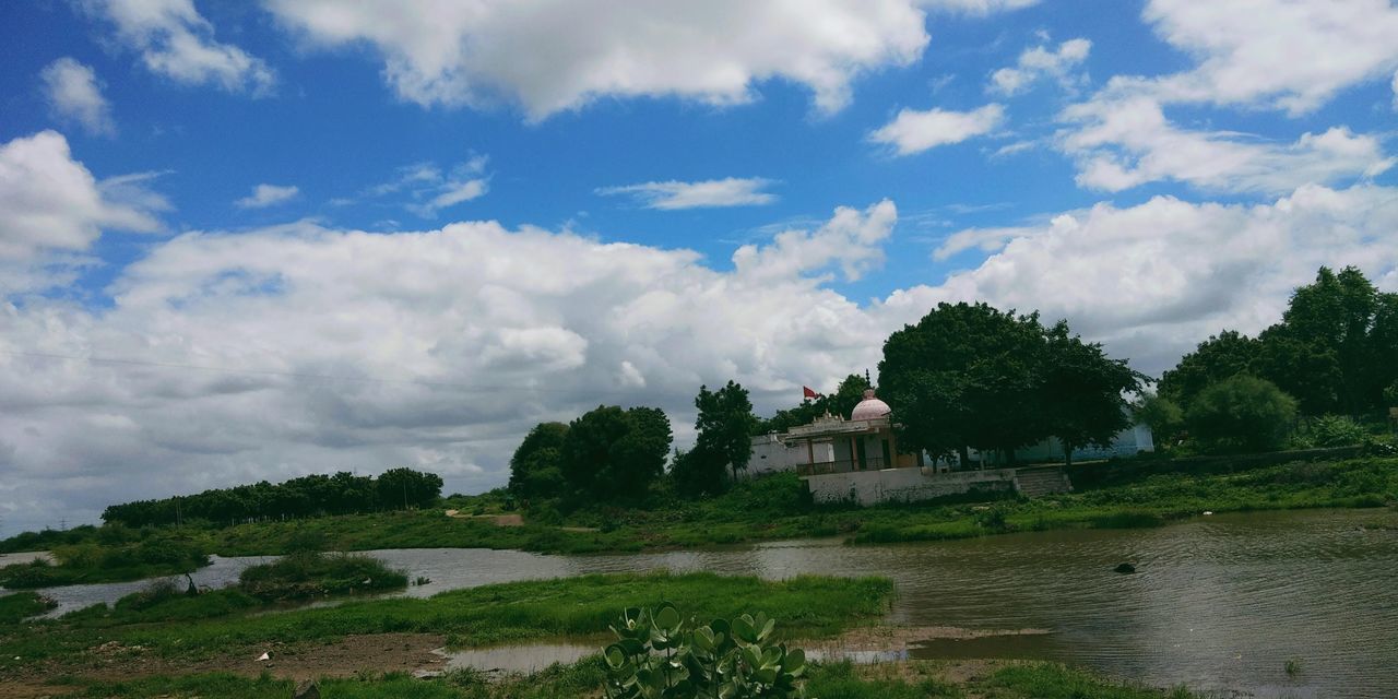 cloud, sky, rural area, water, plant, architecture, hill, tree, nature, built structure, environment, building, landscape, no people, scenics - nature, building exterior, travel destinations, travel, land, sea, beauty in nature, tourism, house, outdoors, religion, history, coast, shore, tranquility, day, grass, the past, green, rural scene