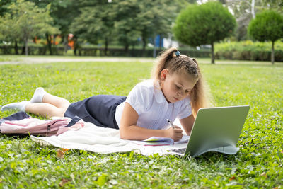 Woman using laptop at park