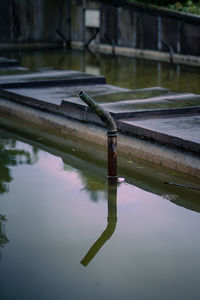 Reflection of metal structure in lake