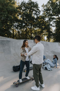 Teenage girl learning how to skate in skate park