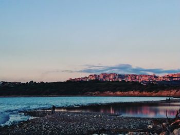 Scenic view of beach against sky during sunset