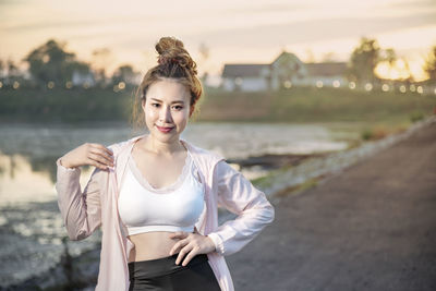 Portrait of young woman standing outdoors